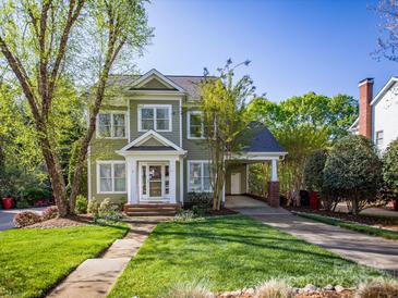 Charming two-story home with a well-manicured lawn, inviting entrance, and convenient covered carport at 547 Ashby Dr, Davidson, NC 28036