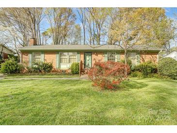 Charming single-story brick home with well-maintained lawn and mature trees at 7000 David Ave, Charlotte, NC 28214