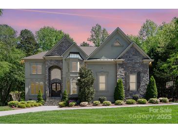 Stunning two-story home with stone accents, arched entryway and lush landscaping at 1029 Seminole Dr, Waxhaw, NC 28173
