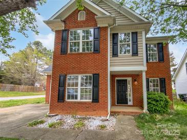 Charming two-story brick home with black shutters and a well-maintained front yard at 15188 Eric Kyle Dr, Huntersville, NC 28078