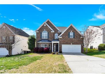 Charming two-story brick home with a two-car garage and well-maintained landscaping at 2275 Laurens Dr, Concord, NC 28027