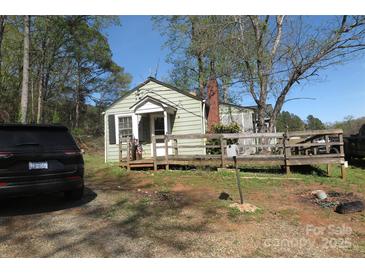 Charming cottage-style home with a wooden porch and easy access ramp surrounded by mature trees and natural landscape at 2547 Gastonia Hwy, Lincolnton, NC 28092