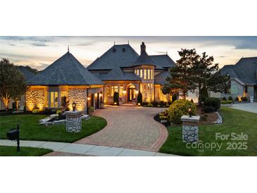 Stunning exterior view of luxurious home with stone accents, professional landscaping, and circular driveway at 325 Ivy Arbor Cir, Rock Hill, SC 29732