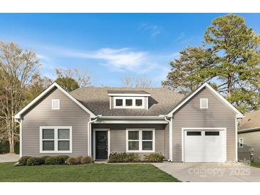 Charming single-Gathering home featuring a grey exterior, well-manicured lawn, and an attached one-car garage at 3708 Small Ave, Charlotte, NC 28269