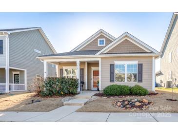 Charming single-story home with a covered porch, manicured lawn, and a welcoming front entrance at 530 Kiser Ln, Locust, NC 28097
