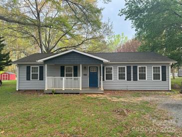 Charming single-story home featuring a welcoming front porch and a blue front door with dark shutters at 5319 Springdale Ave, Mint Hill, NC 28227
