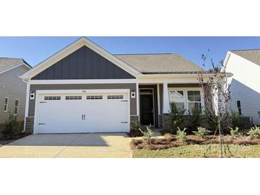 Charming home featuring a two-car garage and beautifully landscaped front yard at 1030 Mapletree Ln, Indian Trail, NC 28079