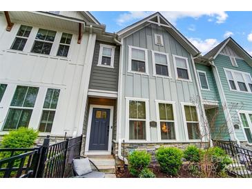 Charming townhouse with gray siding, stone accents, and a well-manicured front yard at 1112 Drummond Ave, Charlotte, NC 28205