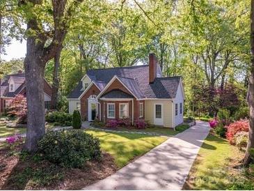 Inviting two-story home with brick and siding, a well-manicured lawn, and a driveway leading to a beautiful property at 1220 Oakwood Ave, Gastonia, NC 28052