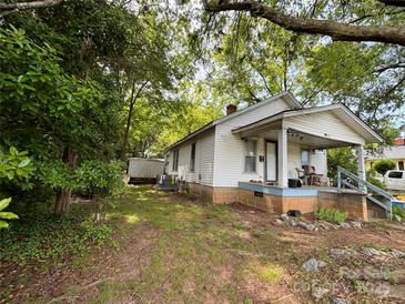 Charming single story home with covered front porch and lush green trees at 142 26Th Sw St, Hickory, NC 28602