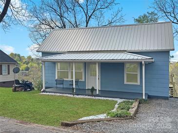 Charming light blue home featuring a metal roof and inviting covered front porch at 2210 22Nd Avenue Se Ct, Hickory, NC 28602