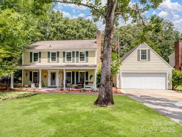 Charming two-story home with a well-maintained lawn and inviting front porch, perfect for relaxing outdoors at 2248 Lawton Bluff Rd, Charlotte, NC 28226