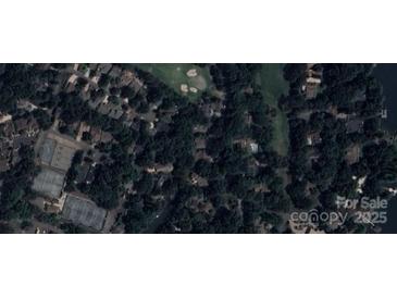 An aerial view of a residential area near a golf course, tennis courts, and waterfront at 4 Sunrise Point Rd, Clover, SC 29710
