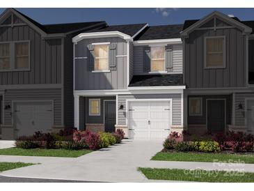 Charming townhome with gray siding, white trim, and a well-manicured front yard at 4333 Summit Woods Dr, Charlotte, NC 28216