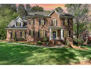 Beautiful brick home with a manicured lawn and stately entrance at 4511 Morning Dove Ct, Denver, NC 28037