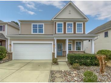 Charming two-story home with a well-manicured lawn, attached garage, and welcoming front porch at 78162 Rillstone Dr, Lancaster, SC 29720