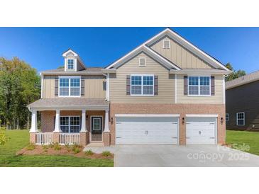 Charming two-story home features a brick-accented front, three-car garage, and covered porch at 8067 Kennesaw Dr, Gastonia, NC 28056