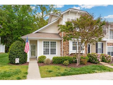 Charming home featuring stone accents, a manicured lawn, and a welcoming front entrance at 969 Copperstone Ln, Fort Mill, SC 29708