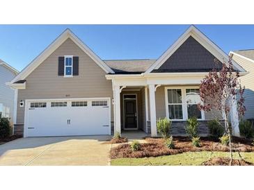 Charming one-story home features a two-car garage and manicured front yard landscaping at 1046 Mapletree Ln, Indian Trail, NC 28079