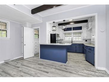 Charming kitchen with stainless steel appliances, blue cabinets, and a breakfast bar at 105 Deaver St, Chester, SC 29706