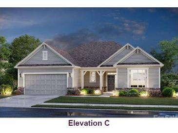 Beautiful single-story home featuring a two-car garage, well-manicured lawn, and inviting front porch at 1280 Coppergate Dr, Salisbury, NC 28147