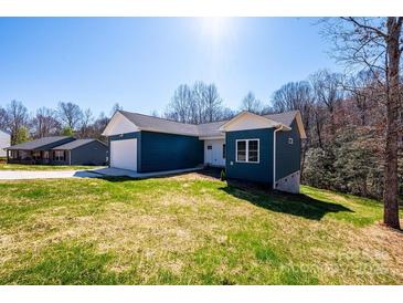 Inviting blue home with white trim, set on a lush green lawn in a tranquil, wooded neighborhood at 1314 39Th Street Sw Cir, Hickory, NC 28602