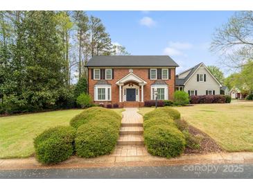 Charming brick home with a manicured front yard and a welcoming walkway, offering classic curb appeal at 1736 Cavendale Dr, Rock Hill, SC 29732