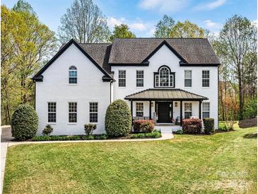 Charming two-story brick home with manicured lawn and inviting curb appeal at 1840 Sapona Ct, Denver, NC 28037