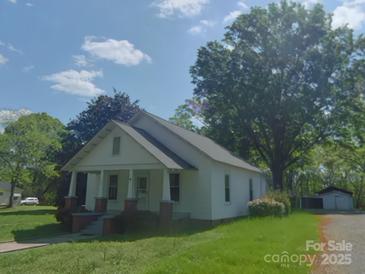 Charming single-story home with front porch and mature trees at 224 Mcclain St, York, SC 29745