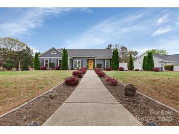 Charming single-story home featuring a well-manicured lawn and inviting yellow front door at 4808 Truscott Rd, Charlotte, NC 28226