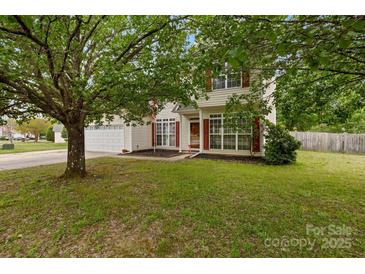 Traditional two-story home with mature trees and well-kept lawn at 5519 Burning Ridge Dr, Monroe, NC 28110