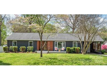 Charming single-story home with mature landscaping, a modern facade, and an inviting front porch at 6100 Rose Valley Dr, Charlotte, NC 28210