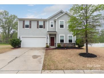 Charming two-story home with a well-manicured lawn and attached two-car garage at 7217 Cedarfield Rd, Charlotte, NC 28227