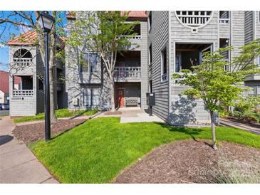 Attractive townhome exterior with cedar shake siding and lush lawn at 9025 J M Keynes Dr # 69, Charlotte, NC 28262