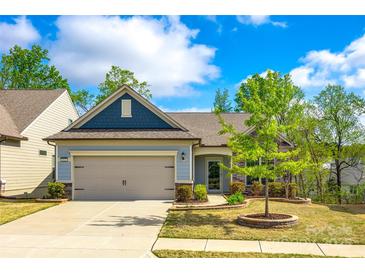 Charming single-story home with a well-manicured lawn, lovely landscaping, and a two-car garage at 1625 Carolina Orchards Blvd, Fort Mill, SC 29715