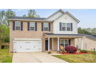 Charming two-story home with a well-manicured lawn and a spacious two-car garage at 200 Boysenberry Dr, China Grove, NC 28023