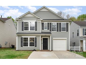 Charming two-story home with gray siding, black shutters, a well-kept lawn, and attached garage at 2005 Dunsmore Ln, Waxhaw, NC 28173