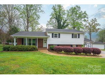 Charming two-story home with manicured front yard and traditional architectural details at 205 Gamble Ave, Bessemer City, NC 28016