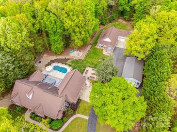 Expansive property with a swimming pool, lush landscaping, and a detached garage surrounded by mature trees at 2470 Highway 557 Rd, Clover, SC 29710