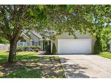 Charming single-story home featuring a two-car garage and well-manicured front yard with mature trees at 2945 Christian Scott Ln, Charlotte, NC 28214