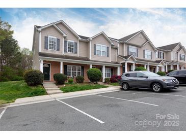 Inviting townhome exterior with manicured landscaping and a convenient parking area at 3138 Golden Dale Ln, Charlotte, NC 28262