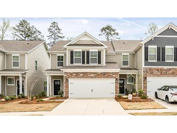 Charming two-story townhome featuring a two-car garage, neutral siding, and a manicured front lawn at 4112 Steel Way, Sherrills Ford, NC 28673