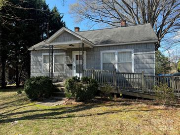 Charming single-story home with a ramp, small porch, and mature trees on a sunny day at 523 29Th Avenue Nw Dr, Hickory, NC 28601