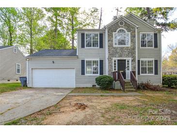 Charming two-story home with stone accents, black shutters and a two-car garage at 6020 Running Deer Rd, Charlotte, NC 28214
