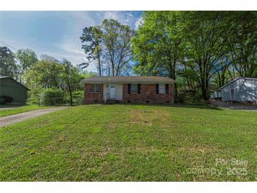 Charming single-story brick home featuring a well-maintained lawn and mature trees at 619 Center St, Gastonia, NC 28054