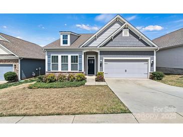 Charming single-story home featuring a two-car garage, manicured lawn, and inviting curb appeal at 7850 Fountaingrass Ln, Sherrills Ford, NC 28673