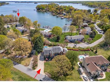 Stunning aerial view of a waterfront property with mature trees, private boat slip, and neighborhood pool at 7980 Bradford Ln, Denver, NC 28037