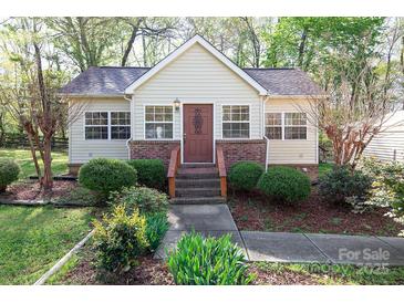 Charming one-story home featuring updated landscaping and inviting front porch at 11100 Pine Grove Ave, Mint Hill, NC 28227