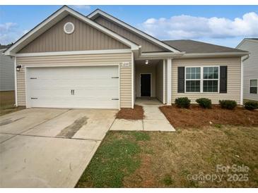 Charming single-story home featuring a two-car garage, neutral siding, and well-maintained landscaping at 1235 Culver Spring Way, Charlotte, NC 28215
