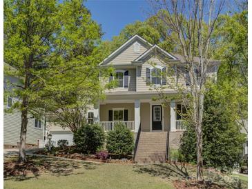 Charming two-story home featuring a welcoming front porch and landscaped front yard at 14103 Grand Traverse Dr, Charlotte, NC 28278